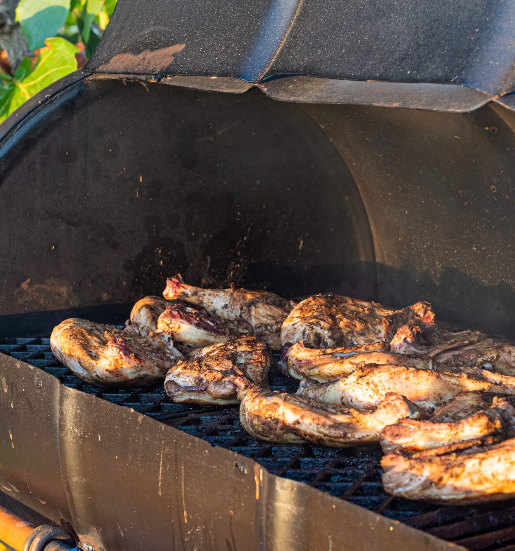 Image showing a jerk chicken cooked in a typical Caribbean style BBQ made from an old oil drum