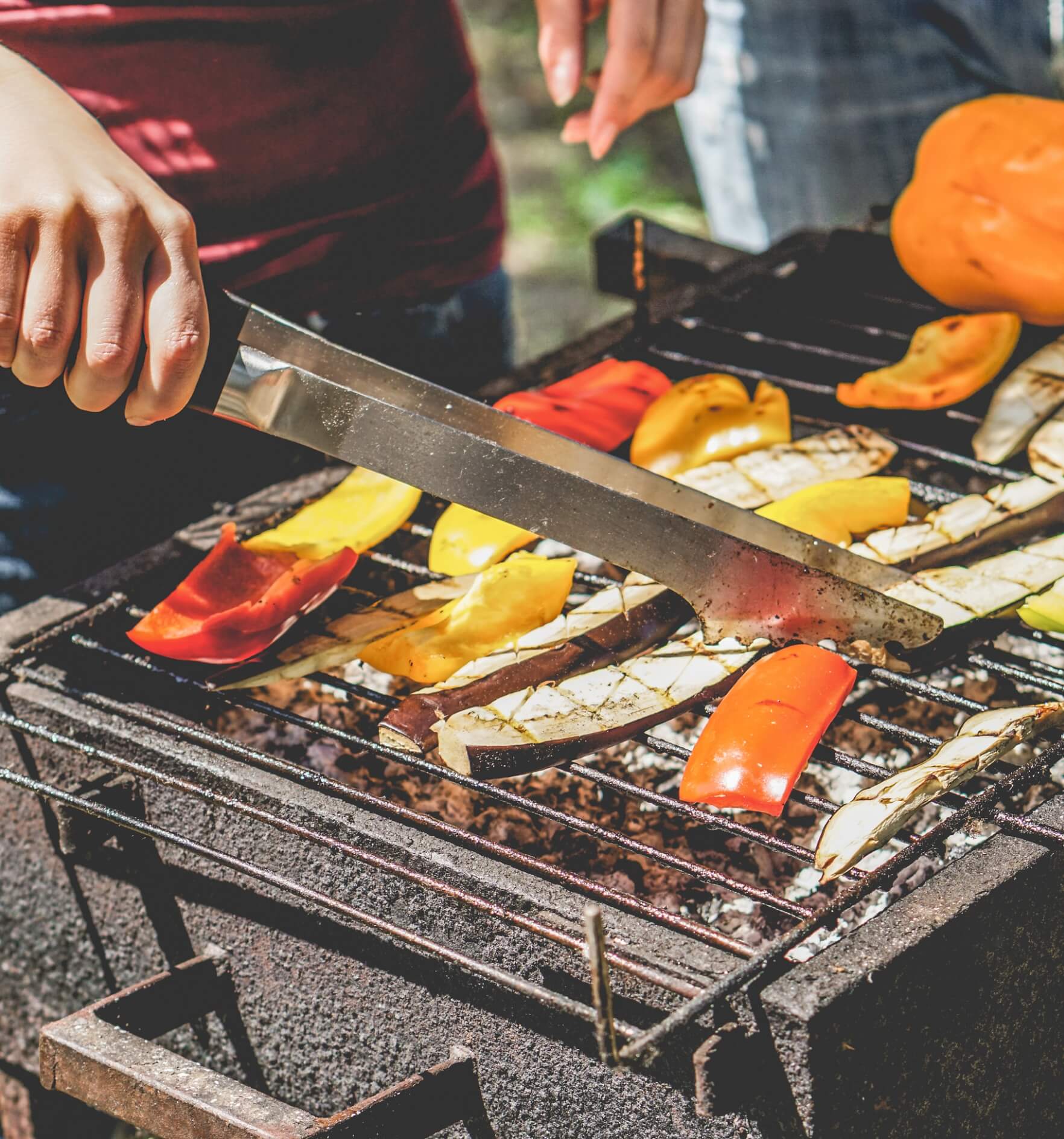 Image showing a man grilling veggies on a barbecue